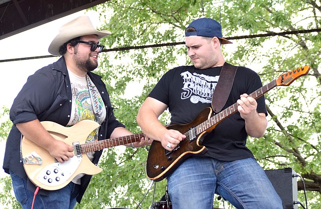 Photo by Mike Eckels Carter Beggs (left) and Cole Reeves played a guitar duet during the 64th Annual Decatur Barbecue at Veterans Park in Decatur Aug. 5. Beggs and Reeves first performed together on the same stage during the 2010 Barbecue concert as the Bobbycolecarter band.