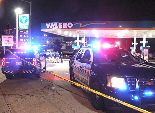 The Sentinel-Record/Richard Rasmussen FATAL SHOOTING: Hot Springs police work the scene of a fatal shooting late Monday at the Valero gas station, 1201 Central Ave. Officers blocked off the entire parking lot at the corner of Grand and Central avenues while the scene was processed.