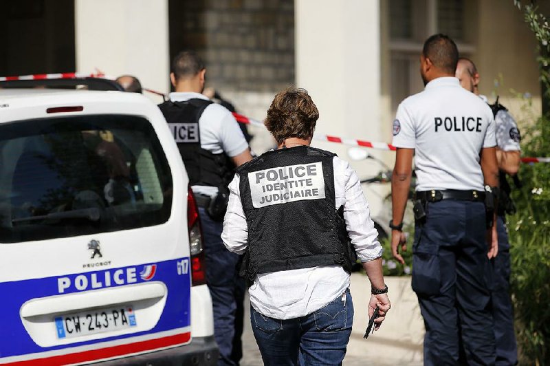 French police officers work Wednesday at the scene where soldiers were struck by a vehicle in the Paris suburb of Levallois-Perret. 