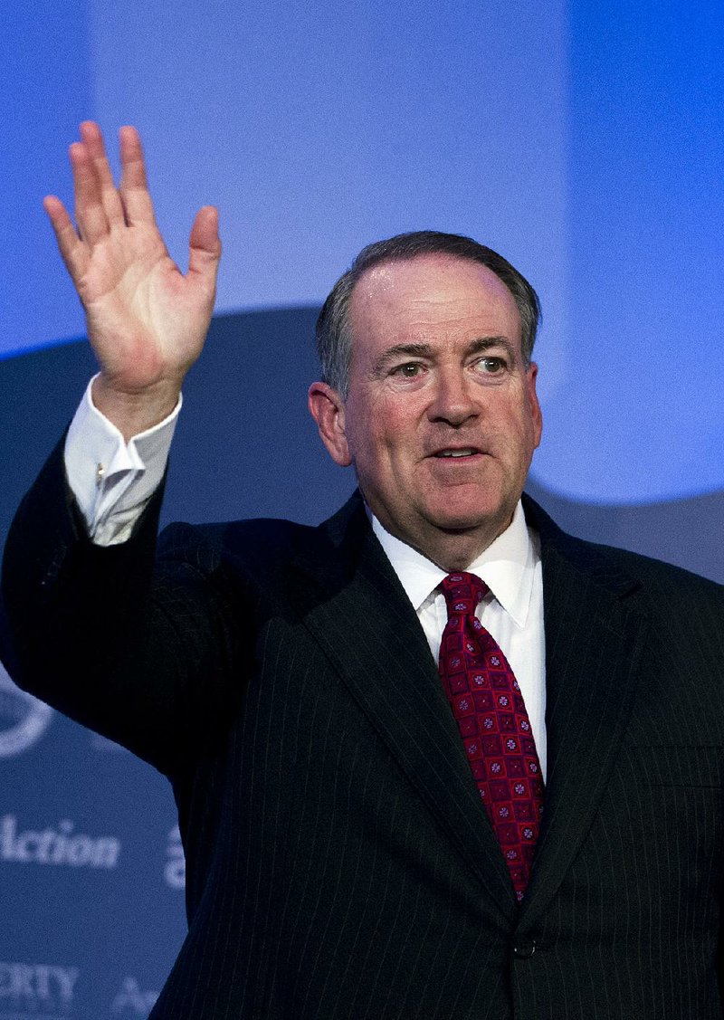 Former Arkansas Gov. Mike Huckabee waves to the crowd after speaking during the Values Voter Summit, held by the Family Research Council Action, Friday, Sept. 25, 2015, in Washington.