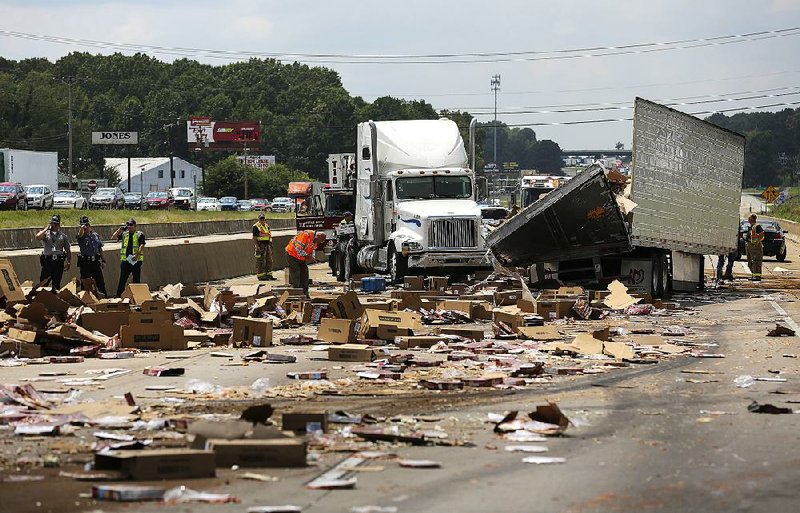 Arkansas state troopers investigate after a westbound truck hauling frozen pizzas hit the Mabelvale overpass on Interstate 30 on Aug. 9, 2017, causing the interstate to be shut down. No injuries were reported from the wreck.  