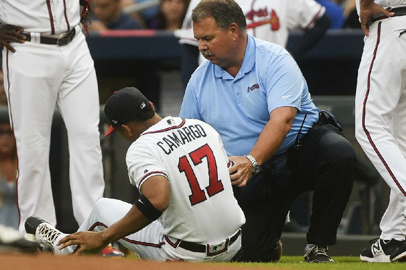 Atlanta Braves rookie shortstop Johan Camargo (center) was placed on the disabled list after suffering a bone bruise in his right knee while jogging onto the field Tuesday at SunTrust Park in Atlanta.