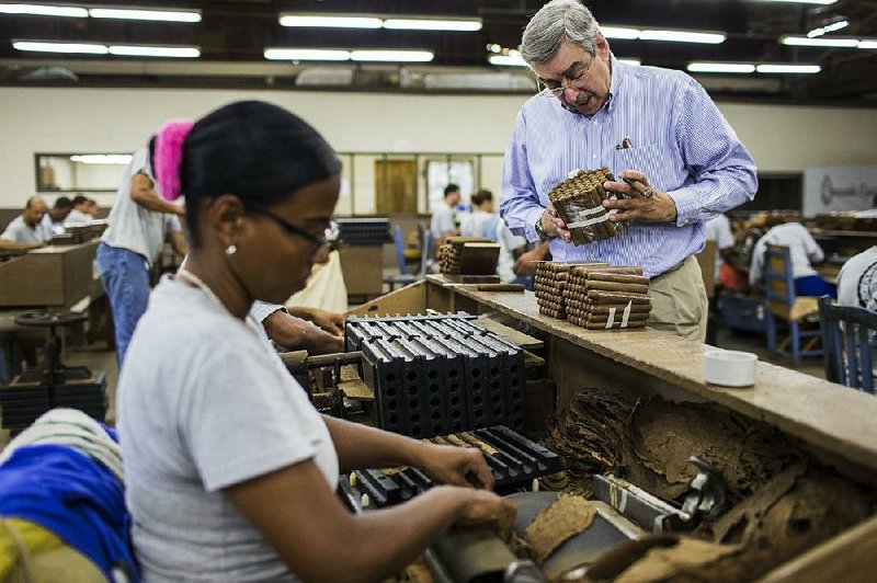 Owner Manuel Quesada inspects a bundle of cigars at his Quesada Cigars plant in the Dominican Republic. For a foreign cigar-maker to break into the U.S. market can cost tens of thousands of dollars.