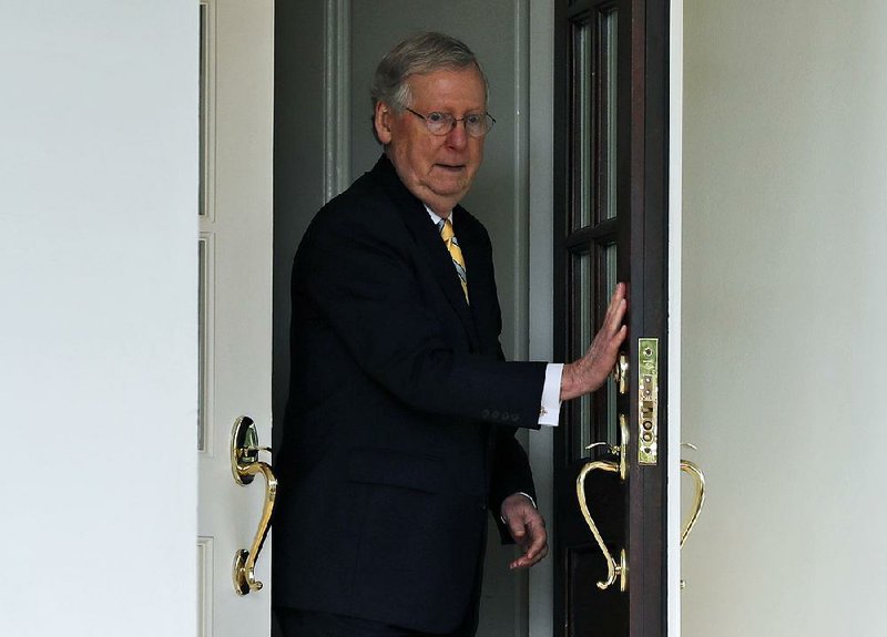 Senate Majority Leader Mitch McConnell steps out of the West Wing of the White House June 27 to speak with the reporters after he and other Senate Republicans met with President Donald Trump. Trump raised the possibility Thursday that McConnell should step down if he can’t muscle health care and other legislation through the Senate.  