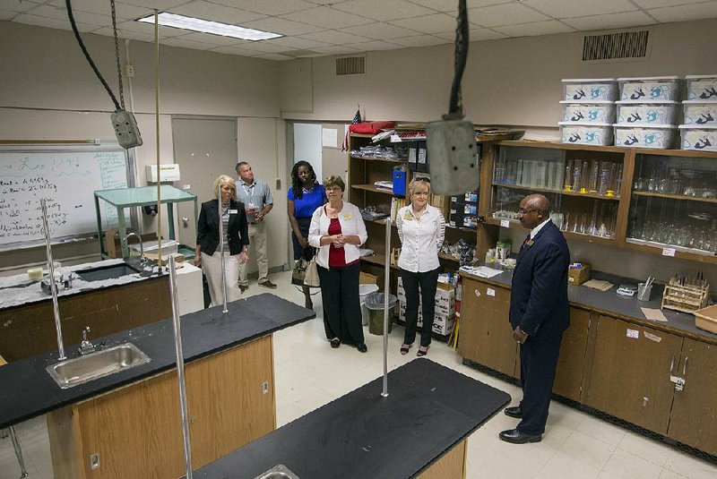 Little Rock School District Deputy Superintendent Marvin Burton (right) takes members of the Arkansas Board of Education on a tour of McClellan High School on Wednesday. One of the board members on the tour, Ouida Newton, said Thursday that what she saw at McClellan shows the need to build a new McClellan High School as well as a new J.A. Fair High. 