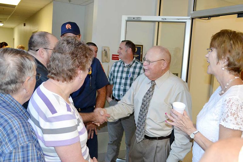 Sgt. Alan Bradley of the Russellville Police Department greets well-wishers at his retirement reception Aug. 3. He said he was overwhelmed by the turnout of friends, fellow officers and citizens. At right is Bradley’s wife, Sandy.