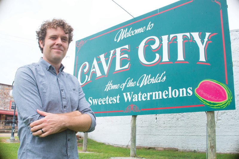 Cave City Mayor Jonas Anderson stands in front of the “welcome” sign in Cave City. Anderson, 34, said he believes it’s time for his generation to step up and take positions such as mayor.