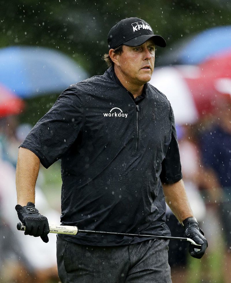 Phil Mickelson watches his putt on the first hole during the second round of the Bridgestone Invitational golf tournament at Firestone Country Club, Friday, Aug. 4, 2017, in Akron, Ohio. 