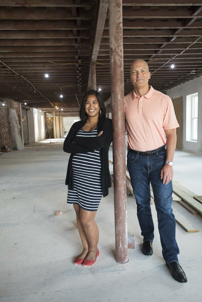 Jeannette Balleza Collins and Rick Webb, founders of Grit Studios, stand in their future offices on the second floor of the Massey Building in Bentonville. The pair are working with startup companies to grow their businesses.