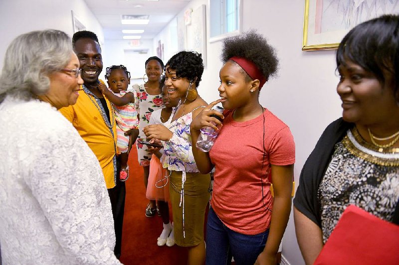 Before church services, Rev. Mary Fowler (left) talks with members of the Youth Choir including (from left) choir director Mario Wilson, Rikia Wilson, 14, Dania Wilson, 9, Antia Wilson, 16, and Mia Wilson, 11, and Linda Williams.