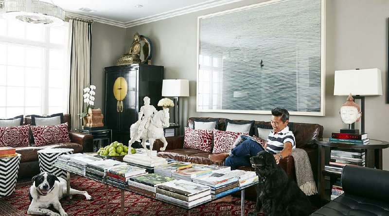 Interior designer Vern Yip sits on a couch with his dogs in his home in Atlanta. With progress in technology, durable rugs made with antimicrobial, stain-resistant fibers have become much more pleasant to the touch and are available in a wide range of styles, making them perfect for pet owners, Yip says.