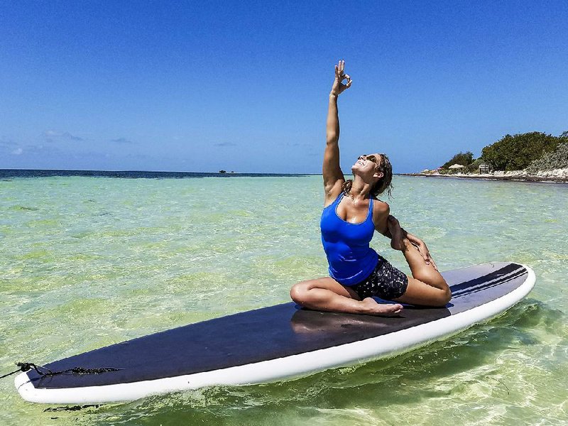 Allison Wilkie demonstrates a yoga pose on a stand-up paddleboard at Bahia Honda State Park. 