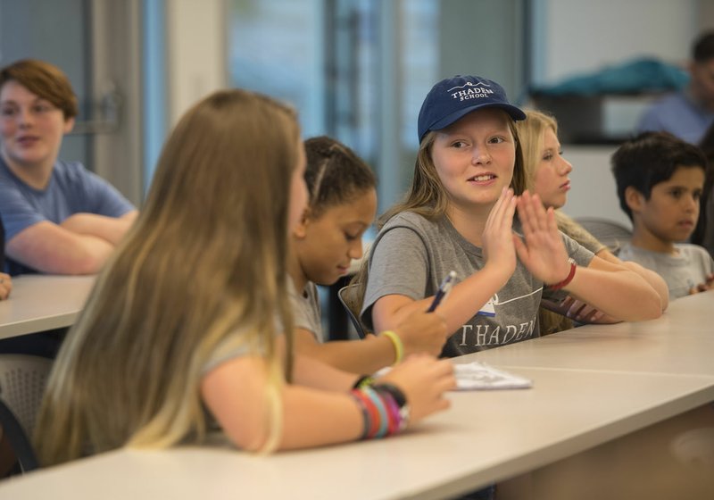 Thaden School seventh-grader Maeve Hints (from right) talks with other seventh-graders, Alora Asuquo and Elizabeth Whalen during an orientation Friday in a room at Crystal Bridges Museum of American Art. The Thaden School, a new independent school opening Monday, is using Crystal Bridges for the first five weeks of the school year as temporary buildings are being set up on its regular campus in downtown Bentonville. The school will open with 45 students in grades seven and nine.