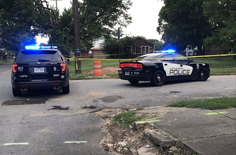 This Little Rock Police Department photo shows officers at the scene of a homicide Saturday night.