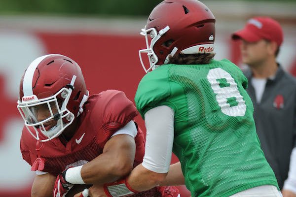 Arkansas running back Chase Hayden (left) receives the ball Tuesday, Aug. 1, 2017, from quarterback Austin Allen during practice at the university's practice field in Fayetteville.