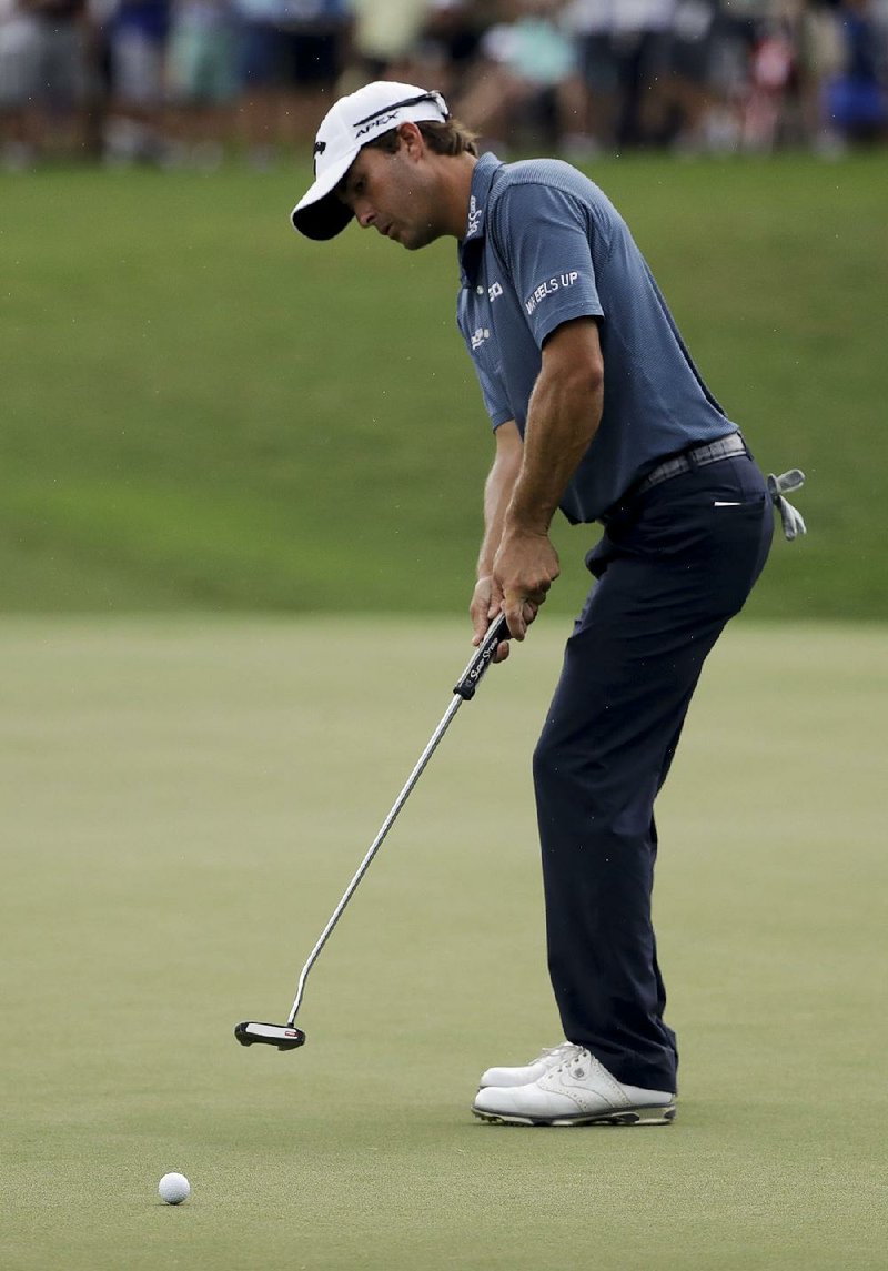 Kevin Kisner (above) putts on the second hole during the third round of the PGA Championship on Saturday at the Quail Hollow Club in Charlotte, N.C. Kisner shot a third-round 72 and is one stroke ahead of Chris Stroud and Hideki Matsuyama entering today’s final round.