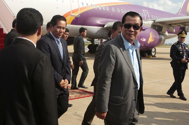 Cambodian Prime Minister Hun Sen (center) arrives at the airport Saturday in Phnom Penh after a quick trip to Laos for talks with Laotian Prime Minister Thongloun Sisoulith.  