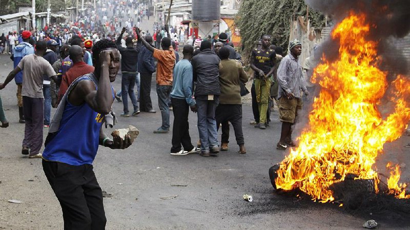 Backers of Kenyan opposition leader Raila Odinga block a road with fiery barricades Saturday in the Kibera slum area of Nairobi in protest of Tuesday’s election results that show President Uhuru Kenyatta winning re-election. Police used live ammunition against rioters in Kibera and fired tear gas at vehicles carrying opposition leaders trying to enter the slum.  