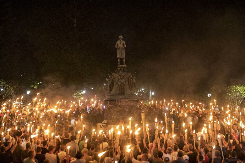 Torch-bearing white nationalists gather around a statue of Robert E. Lee during a demonstration Friday night in Charlottesville, Va. 