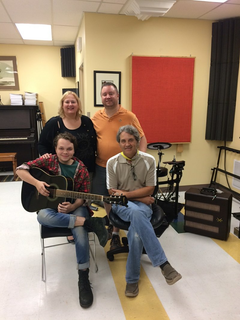 Courtesy photo Eli Marks (left with his guitar), music teacher Dave Singleton, Betsy Brumley-Bernier and Kevin Bernier celebrate the donation of a guitar to Marks courtesy of the I’ll Fly Away Foundation.