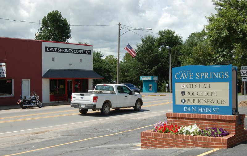 NWA Democrat-Gazette/STACY RYBURN Traffic moves along Main Street Friday in Cave Springs.