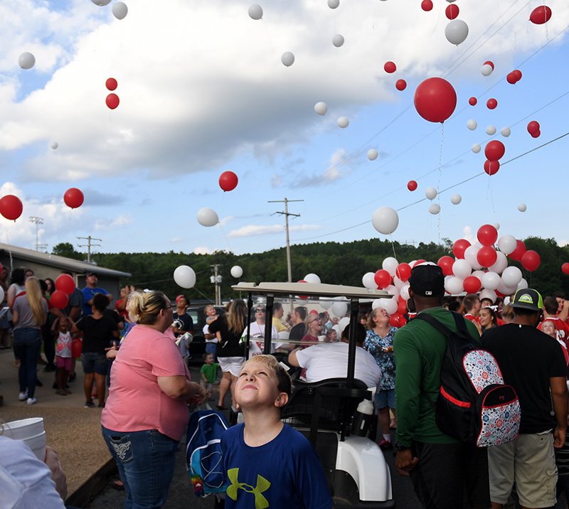 The Sentinel-Record/Mara Kuhn Students, employees and members of the Mountain Pine community gathered Thursday evening for the yearly practice of releasing balloons in celebration of the 17th annual Dr. Morriss Memorial Carnival on campus. Students throughout Garland County will return to campus on Monday for the first day of the 2017-18 school year.