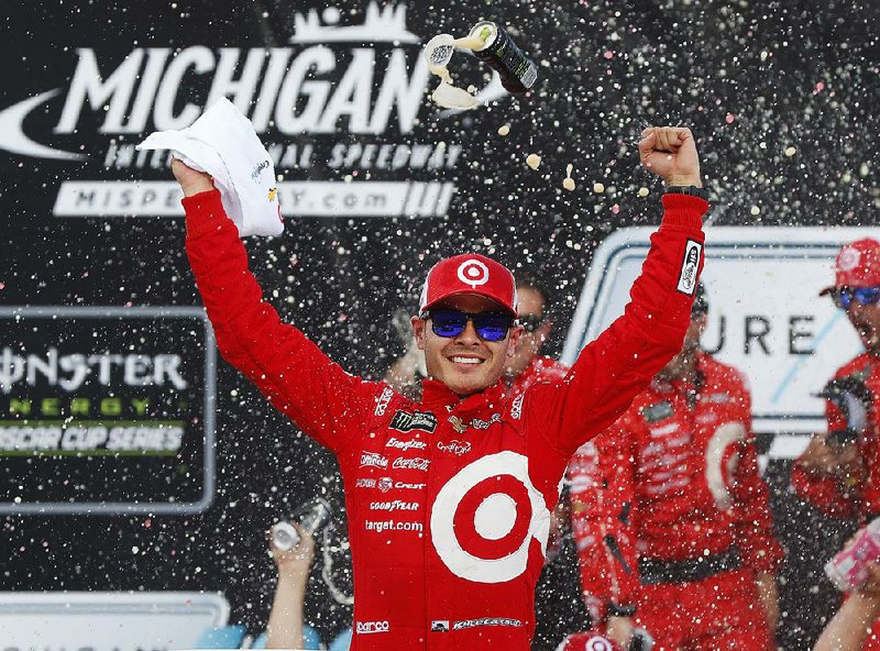 Driver Kyle Larson celebrates his victory in the Michigan 400 on Sunday at Michigan International Speedway in Brooklyn, Mich. Martin Truex Jr. finished second.