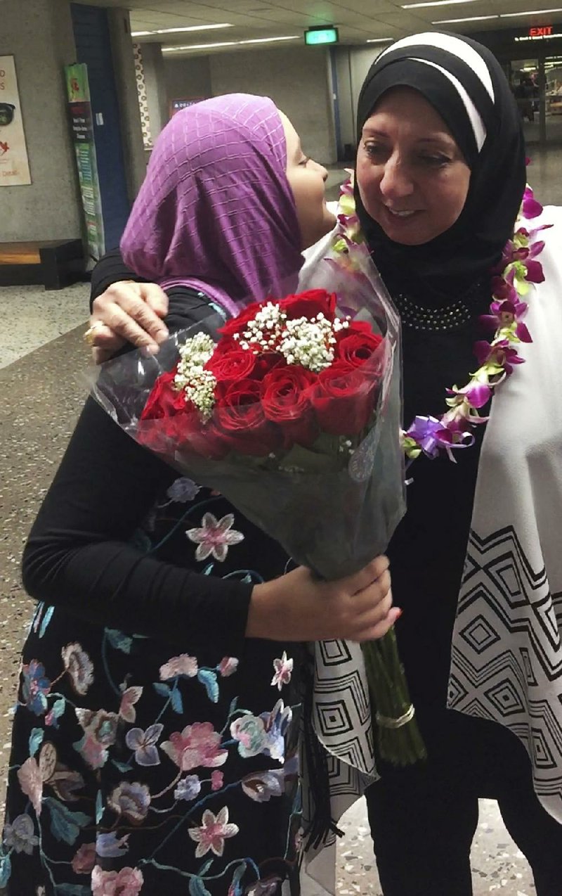 Noran Elshikh (left) greets her grandmother Wafa Yahia at Honolulu’s Daniel K. Inouye International Airport after she arrived  from Syria on Saturday.