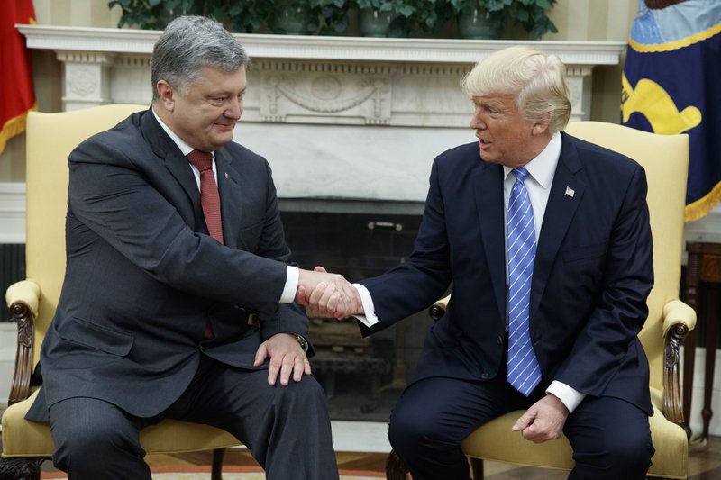 In this June 20, 2017, file photo, President Donald Trump shakes hands with Ukrainian President Petro Poroshenko during a meeting in the Oval Office of the White House in Washington.