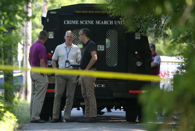 Little Rock Police detectives gather at the scene of a homicide at 25th and Arch streets in south Little Rock on May 8, 2017. The killing is one of 41 so far this year in Little Rock.
