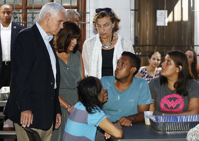 Vice President Mike Pence (left) and his wife, Karen (second from left), meet with Venezuelans on Monday at the Calvary Chapel in Cartagena, Colombia.