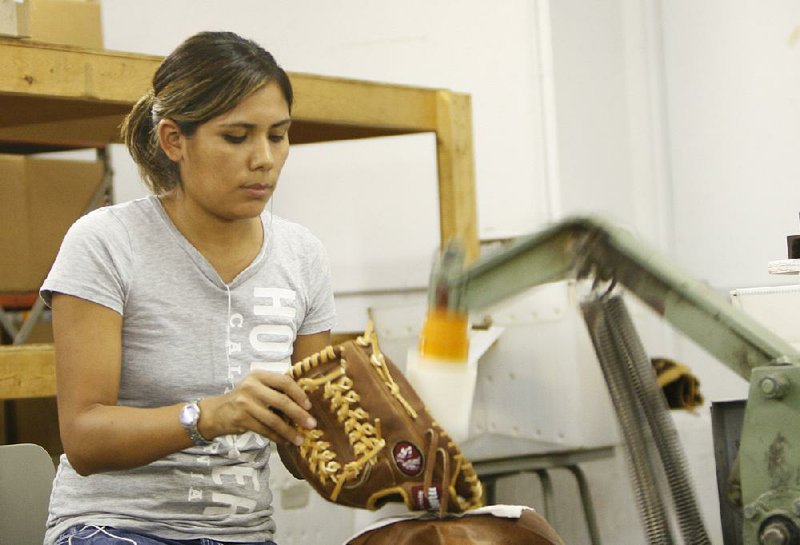 An employee makes a Nokona Athletic Goods Co. baseball glove at the company factory in Nocona, Texas. “Made in America means you believe in our country,” said Carla Yeargin, a glove inspector and tour guide at Nokona, where she worked her way up from janitor. “We have the love for the ballglove, because we made it here.” 
