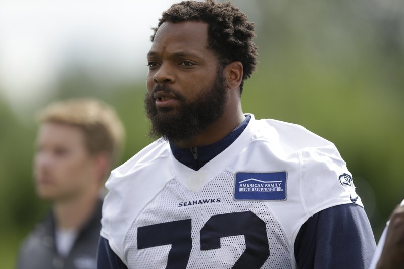 In this June 13, 2017, file photo, Seattle Seahawks defensive end Michael Bennett walks off the field following NFL football practice in Renton, Wash.