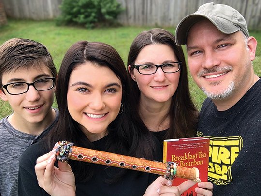 Submitted photo WINNING FAMILY: From left, Aiden, Bailey, Amy and Coy Lothrop found the "Magic Suling," a bamboo flute from "Breakfast Tea & Bourbon" that was hidden in Hot Springs, and won $50,000.