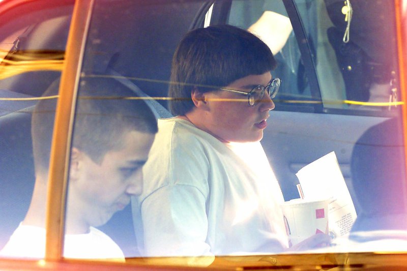 File photo: Convicted Westside Middle School shooters Mitchell Johnson, right, and Andrew Golden, left, sit in a patrol car outside of the Craighead County Courthouse in Jonesboro, Ark., Thursday, April 27, 2000. (AP Photo/Jonesboro Sun, Rodney Freeman)