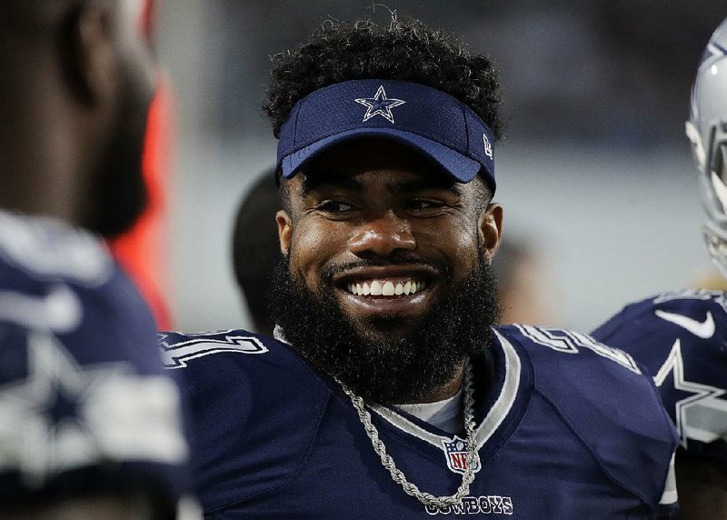 Dallas Cowboys running back Ezekiel Elliott looks on from the sideline during the second half of a preseason NFL football game against the Los Angeles Rams, Saturday, Aug. 12, 2017, in Los Angeles. 