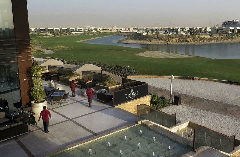 Staff prepare a dining area last week at the Trump International Golf Club clubhouse in Dubai, United Arab Emirates. A Dubai billionaire who built a Trump golf course in the UAE is seeking new Trump-branded business abroad. 