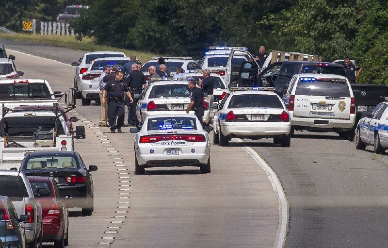 Arkansas Democrat-Gazette/BENJAMIN KRAIN --8/15/17-- 
North Little Rock police and state troopers surround a pickup truck, top right, on Interstate 430 northbound near Interstate 40 after the driver fled police when they approached his vehicle at Cooks Landing. Interstate 430 was shut down for about 30 minutes while a tactical team talked the driver out of the vehicle after stopping on the highway shoulder.
