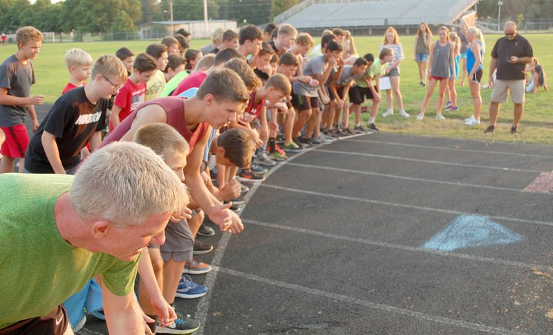 Graham Thomas/Herald-Leader Members of the Siloam Springs boys cross country team line up on the track of Glenn W. Black Stadium to run a one-mile time trial on Tuesday, Aug. 8.