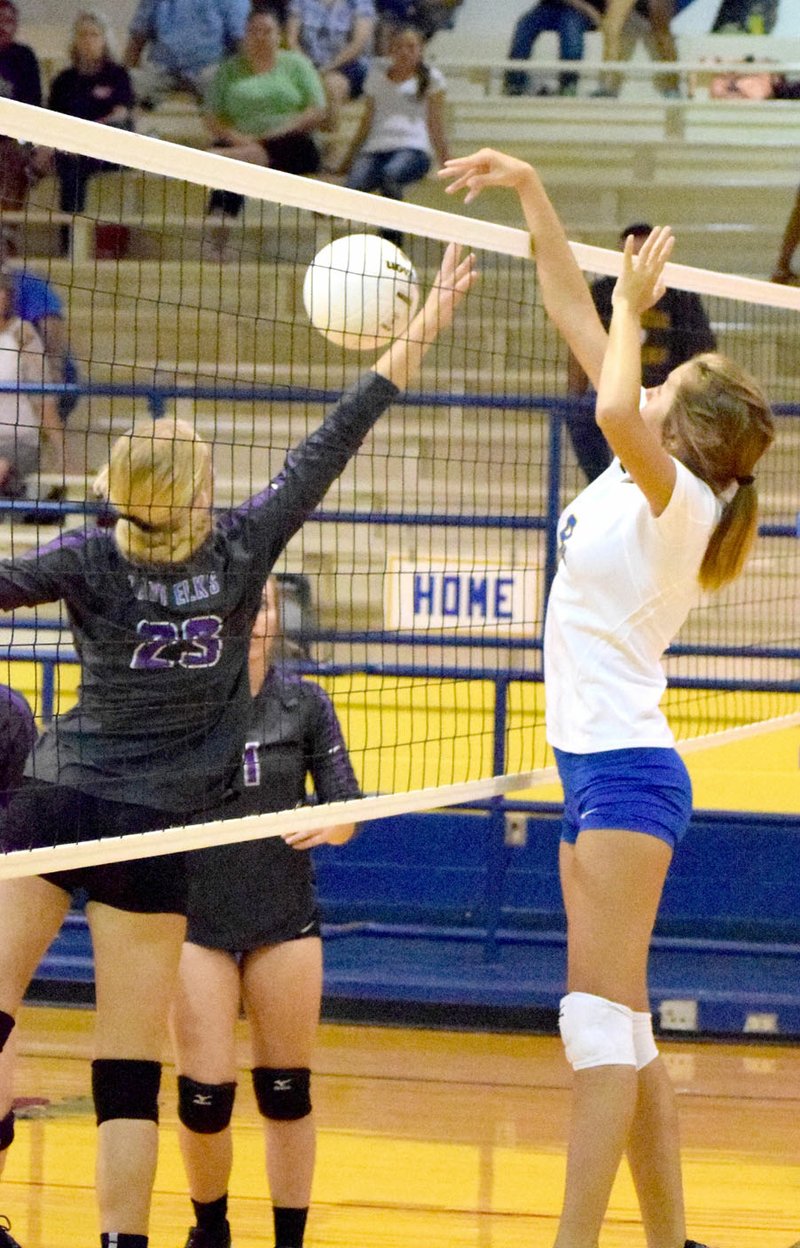 Photo by Mike Eckels Talor Thompson delivered a ball between two Elks players during the Decatur-Elkins volleyball match at Peterson Gym in Decatur last season. The Lady Bulldogs volleyball team begins its 2017 season at home against Northwest Classical Academy Aug. 22 at 4:30 p.m.