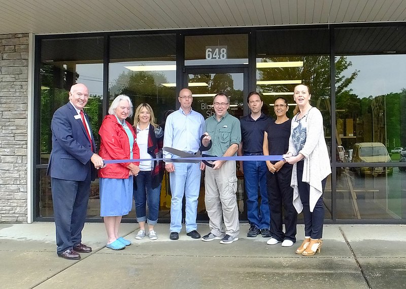 Lynn Atkins/The Weekly Vista Members of the Bella Vista Business Association and Mayor Peter Christie, far left, helped Butch Tetzlaff (holding scissors) cut the ribbon at the Bluebird Shed, located near Duffers in The Village Center on Lancashire Boulevard. He sells food, water and shelter for birds and a few items for birds as well as home decor for people. He&#8217;s evern has bat houses and squirrel feeders.