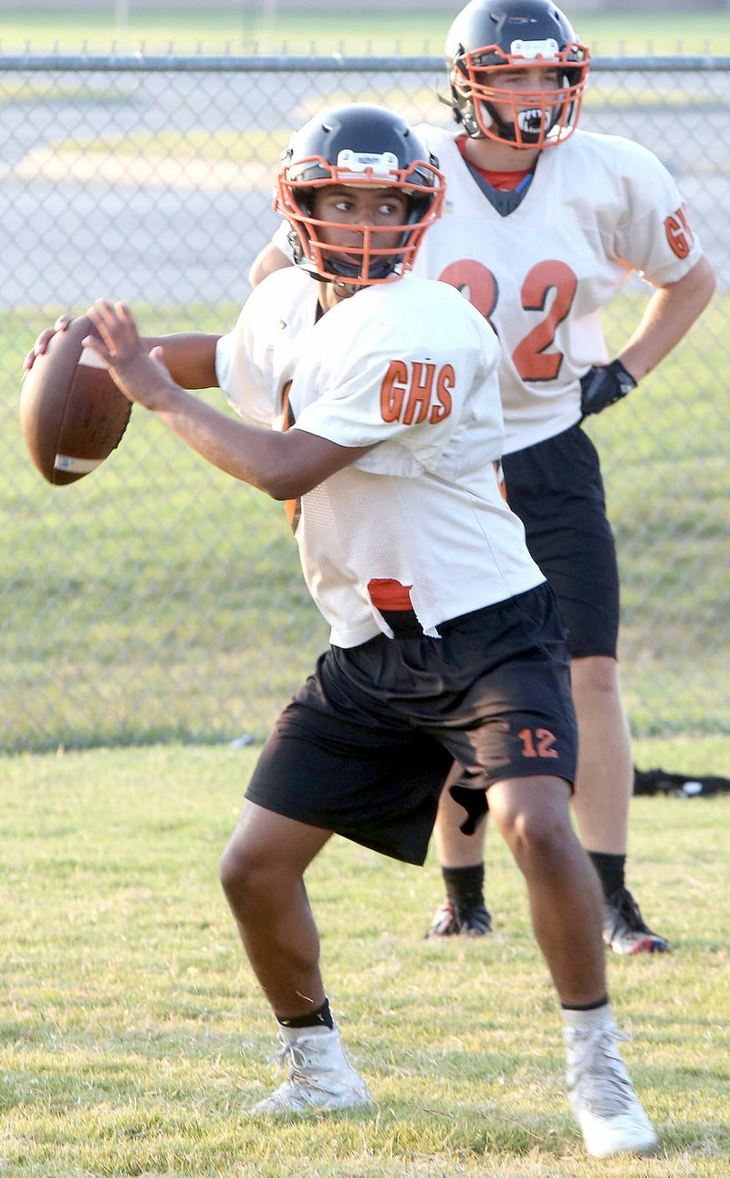 Photo by David Gottschlak Gravette High School football player Tajae White looks for a receiver during drills at Gravette High School on Aug. 9.