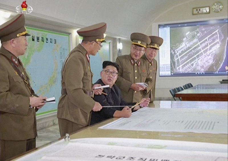 This image made from video of an Aug. 14, 2017, still image broadcast in a news bulletin on Tuesday, Aug. 15, 2017, by North Korea's KRT shows North Korean leader Kim Jong Un receiving a briefing in Pyongyang. North Korea said leader Kim Jong Un was briefed on his military's plans to launch missiles in waters near Guam days after the Korean People's Army announced its preparing to create &quot;enveloping fire&quot; near the U.S. military hub in the Pacific. Independent journalists were not given access to cover the event depicted in this photo. (KRT via AP Video)