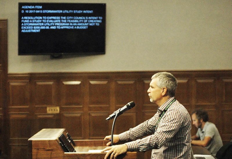 NWA Democrat-Gazette/STACY RYBURN Chris Brown, Fayetteville city engineer, speaks Tuesday at City Hall during a discussion of studying a storm water utility fee for residents in Fayetteville.