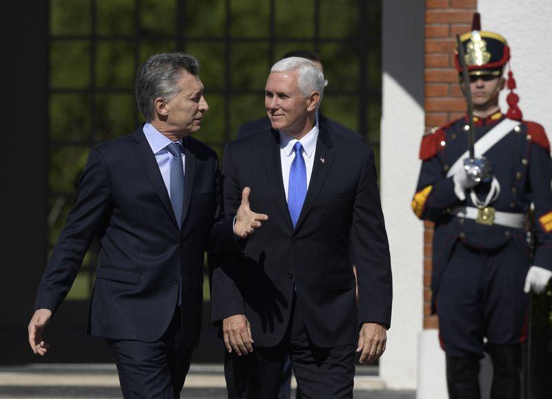 Vice President Mike Pence (right) walks with Argentine President Mauricio Macri on Tuesday at the government residence in Buenos Aires, Argentina. 