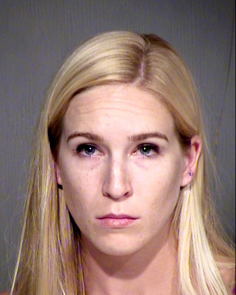This undated photo released by the Maricopa County, Ariz., sheriff's office shows Keri Harwood, who was arrested Sunday, Aug. 13, 2017, on suspicion of five counts each of child molestation and sexual exploitation of a minor. 