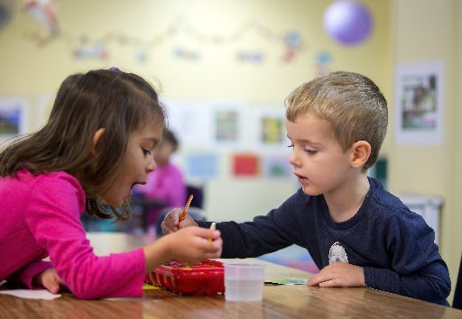 Audrina (cq) Williams, 4, and Eli Trout, 3, paint paper ornaments on Tuesday, Nov. 29, 2016, at the Helen Walton Children's Enrichment Center in Bentonville.