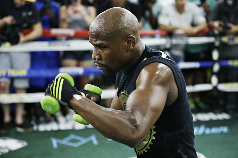 Floyd Mayweather Jr. trains for his scheduled Aug. 26 bout against Conor McGregor in Las Vegas. Mayweather and McGregor were granted a request Wednesday to use smaller 8-ounce gloves.