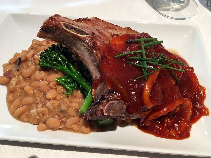 A Vidalia onion and Meyer lemon sauce coats the bone-in pork chop, served  with cannellini beans braised in Lost 40 Pale Ale and peppered bacon and broccoli rabb.
