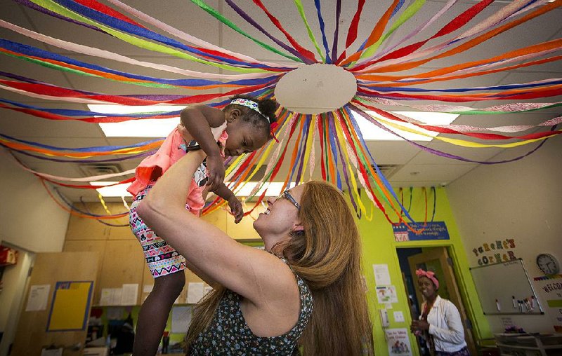 Executive Director Georgia Mjartan plays with Our House Children’s Center student Porter Nelson during her daily rounds Wednesday at the shelter for working homeless families in Little Rock. Mjartan is stepping down after 12 years as executive director of the shelter.